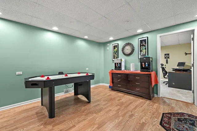 a very nice looking room with a large kitchen table and a refrigerator