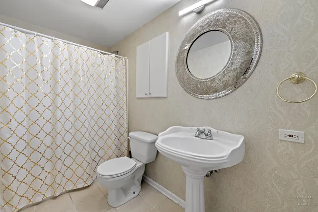 an aerial view of residential houses with outdoor space and parking