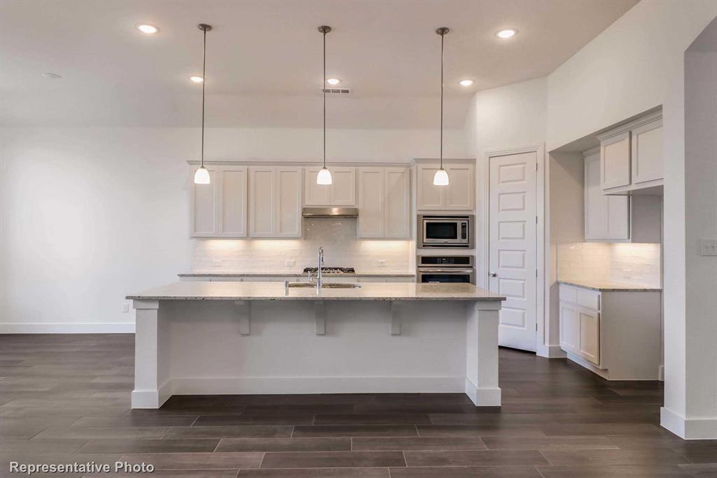 a large kitchen with stainless steel appliances kitchen island a large island in the center