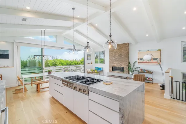 a kitchen that has a stove and a wooden floor