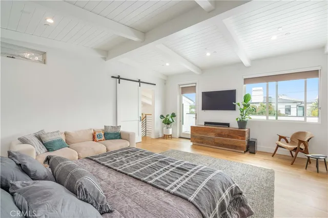 a spacious bedroom with a bed and a couch