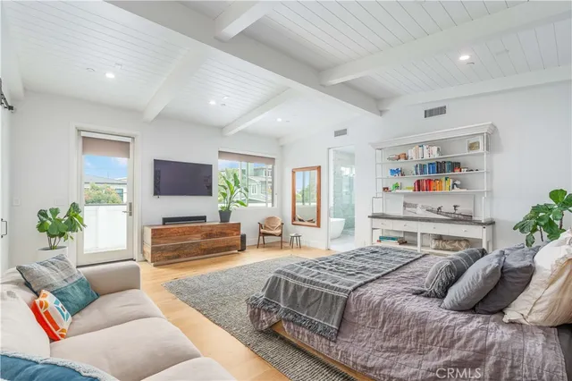 a bedroom with a large bed and a couch