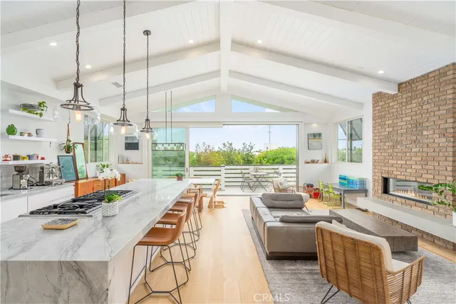 a very nice looking living room with a large window and a table