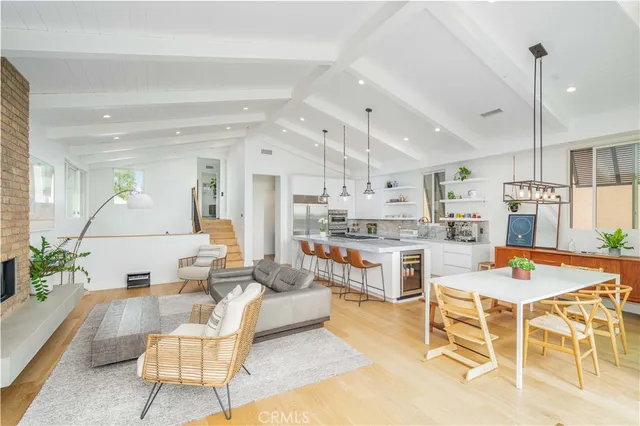 a living room with stainless steel appliances kitchen island granite countertop furniture and a kitchen view