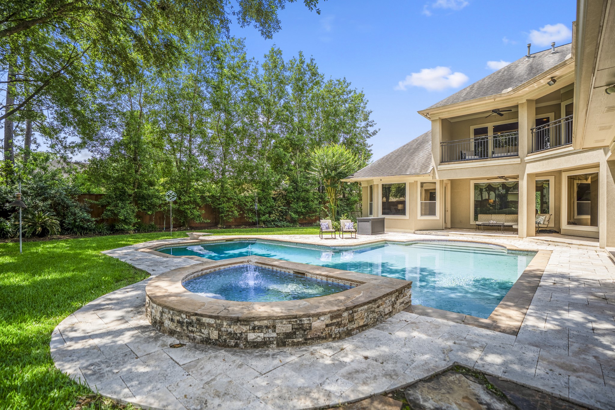 8806 Sterling Gate Circle Spring, TX 77379 - Photo 40 of 40 Another view of this home shows the spa and fountain surrounded by the Travertine patio. An amazing back yard!
