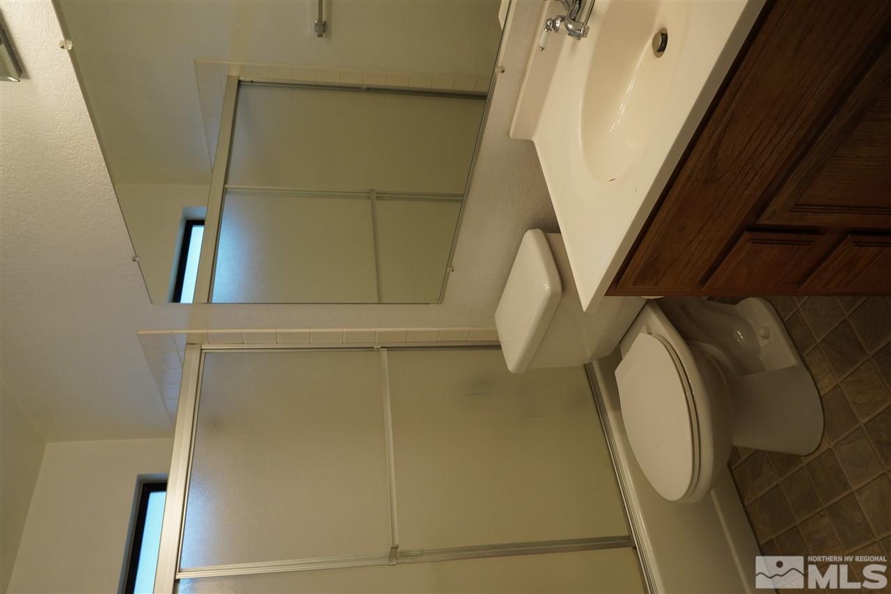 1765 Amarak Way Reno, NV 89523 - Photo 13 of 16 a bathroom with a sink a toilet and shower