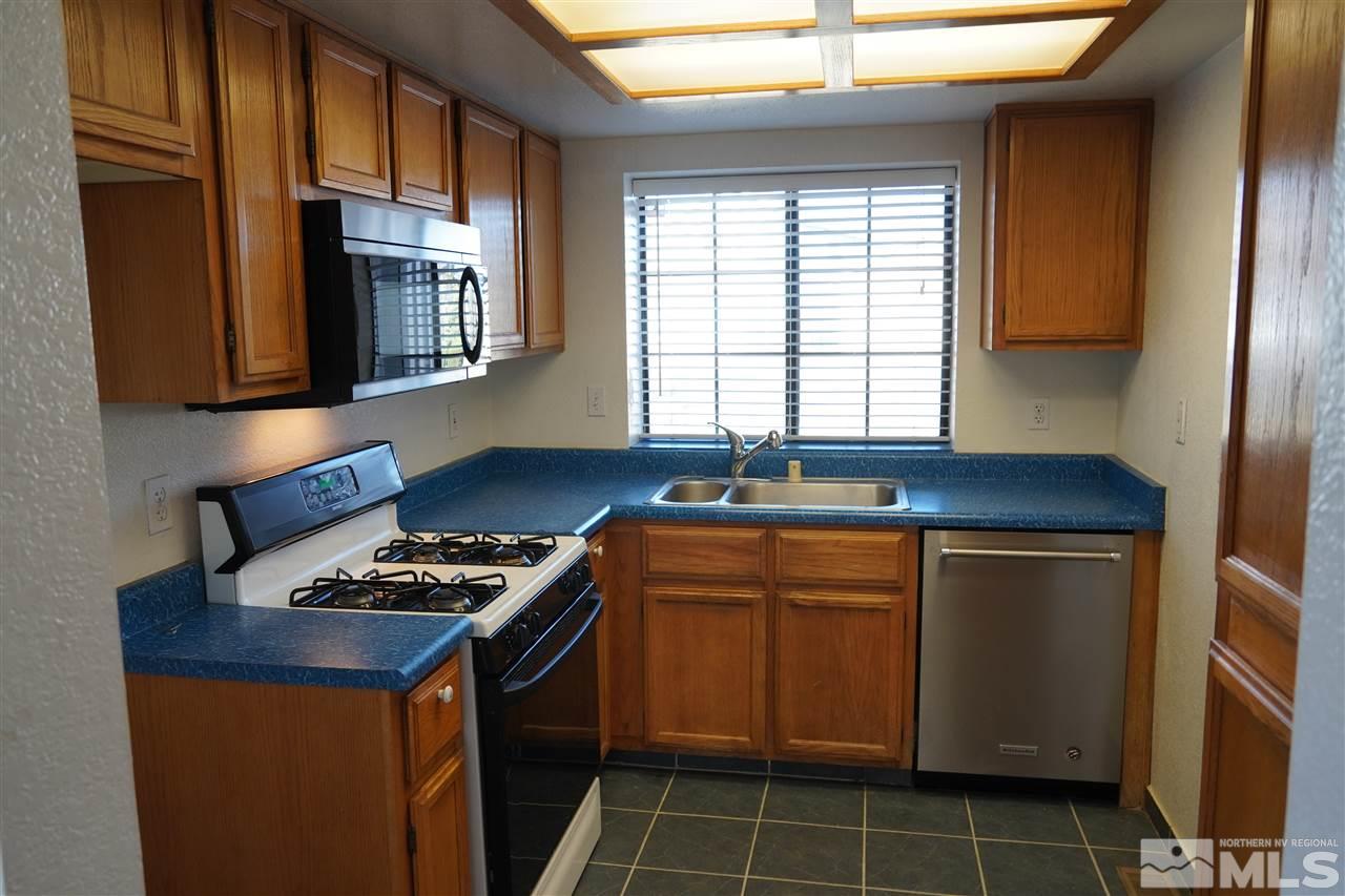 1765 Amarak Way Reno, NV 89523 - Photo 3 of 16 a kitchen with granite countertop a sink stove and cabinets