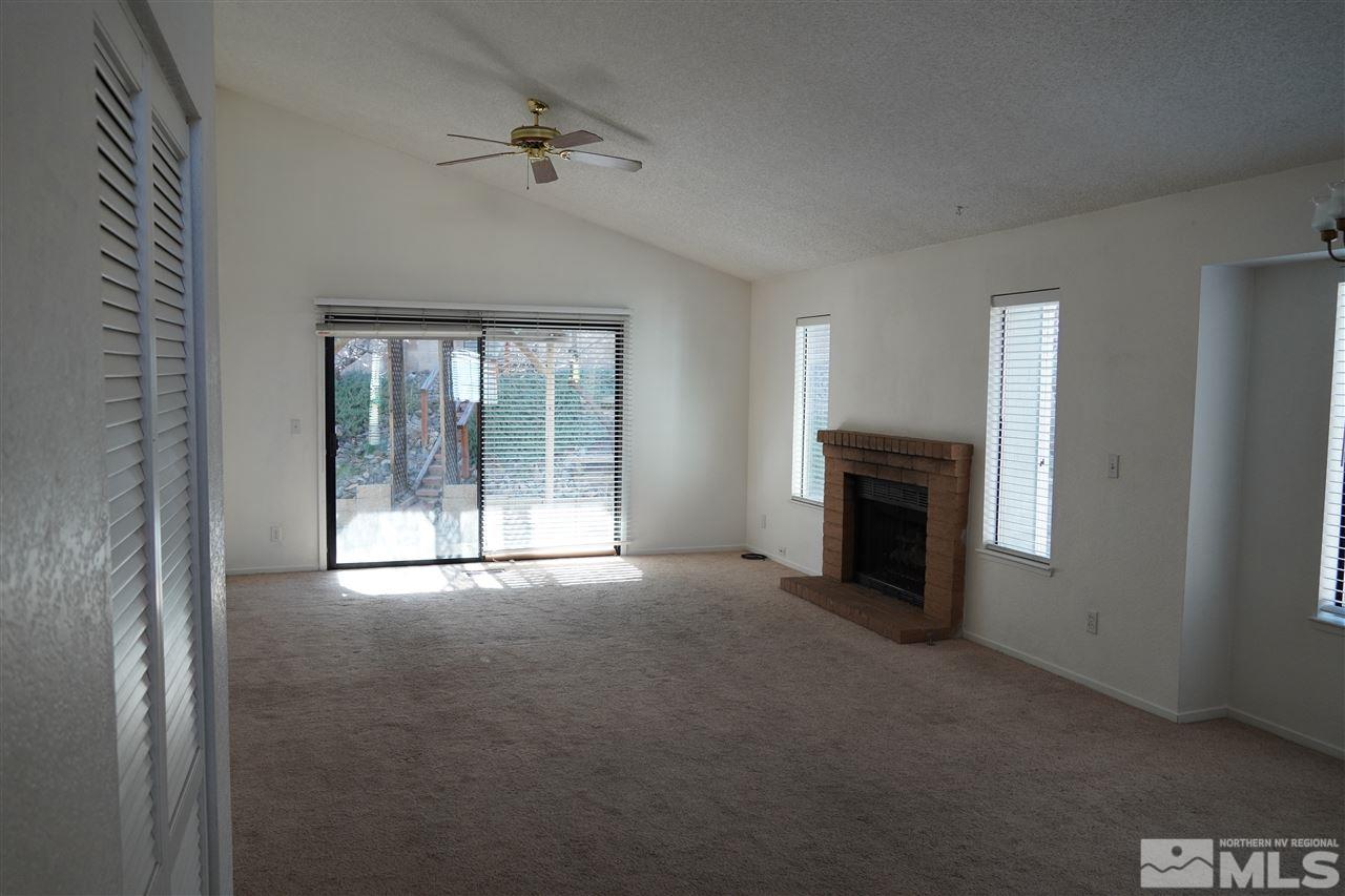1765 Amarak Way Reno, NV 89523 - Photo 7 of 16 a view of an empty room with a fireplace and a window