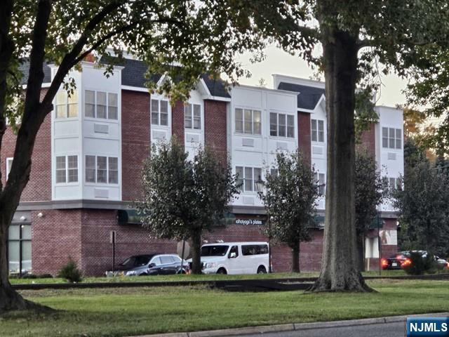 10 Madison, Unit 204 Cresskill, NJ 07626 - Photo 2 of 10 front view of house with a yard