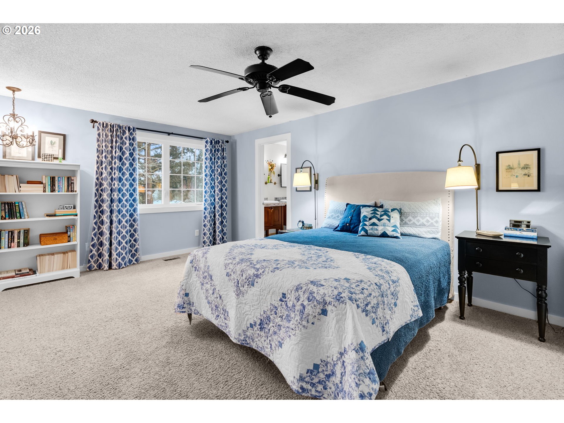 18370 Franklin Way Gladstone, OR 97027 - Photo 23 of 45 a bedroom with a large bed and a chandelier