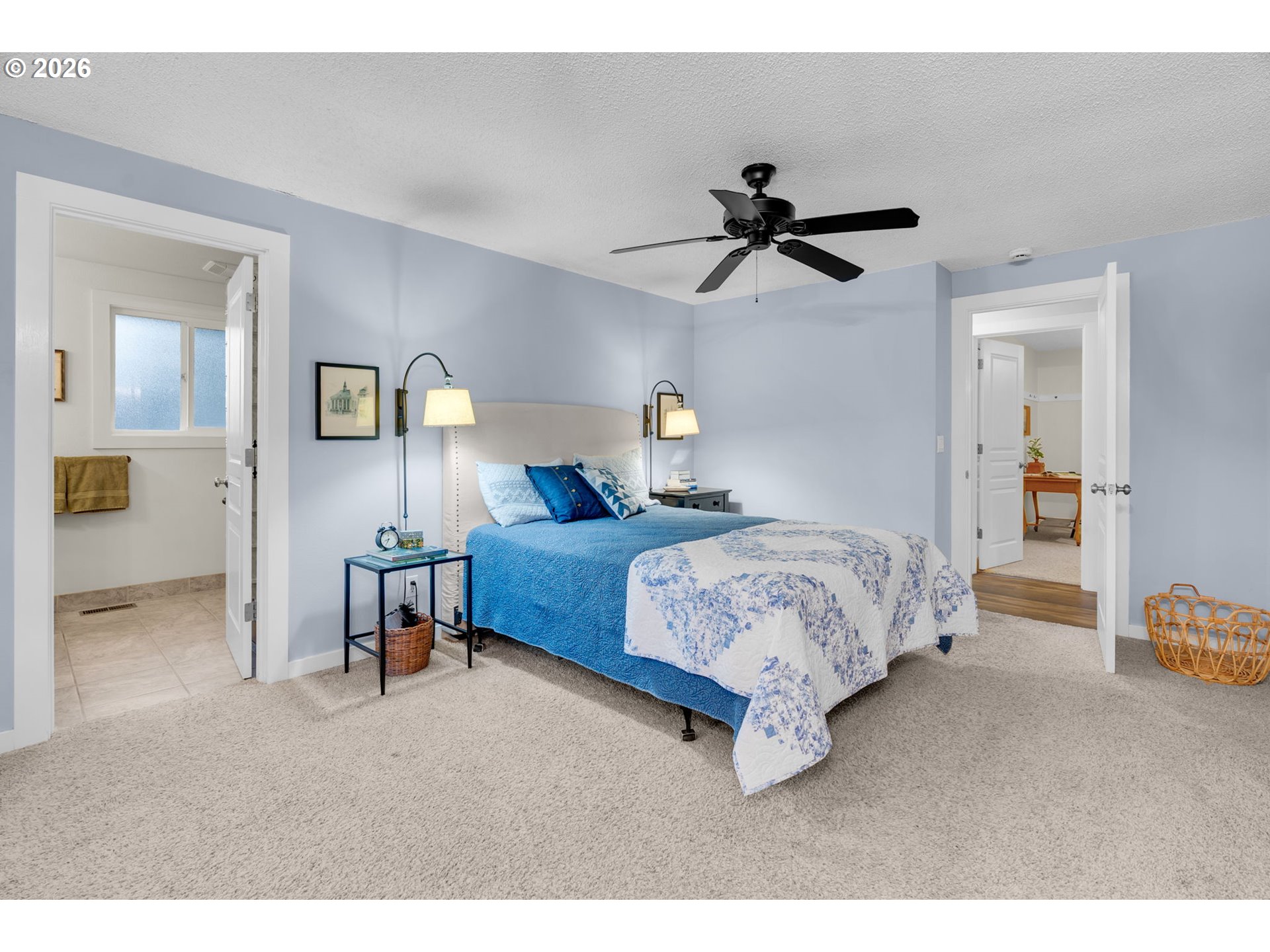 18370 Franklin Way Gladstone, OR 97027 - Photo 24 of 45 a spacious bedroom with a bed a table and chair
