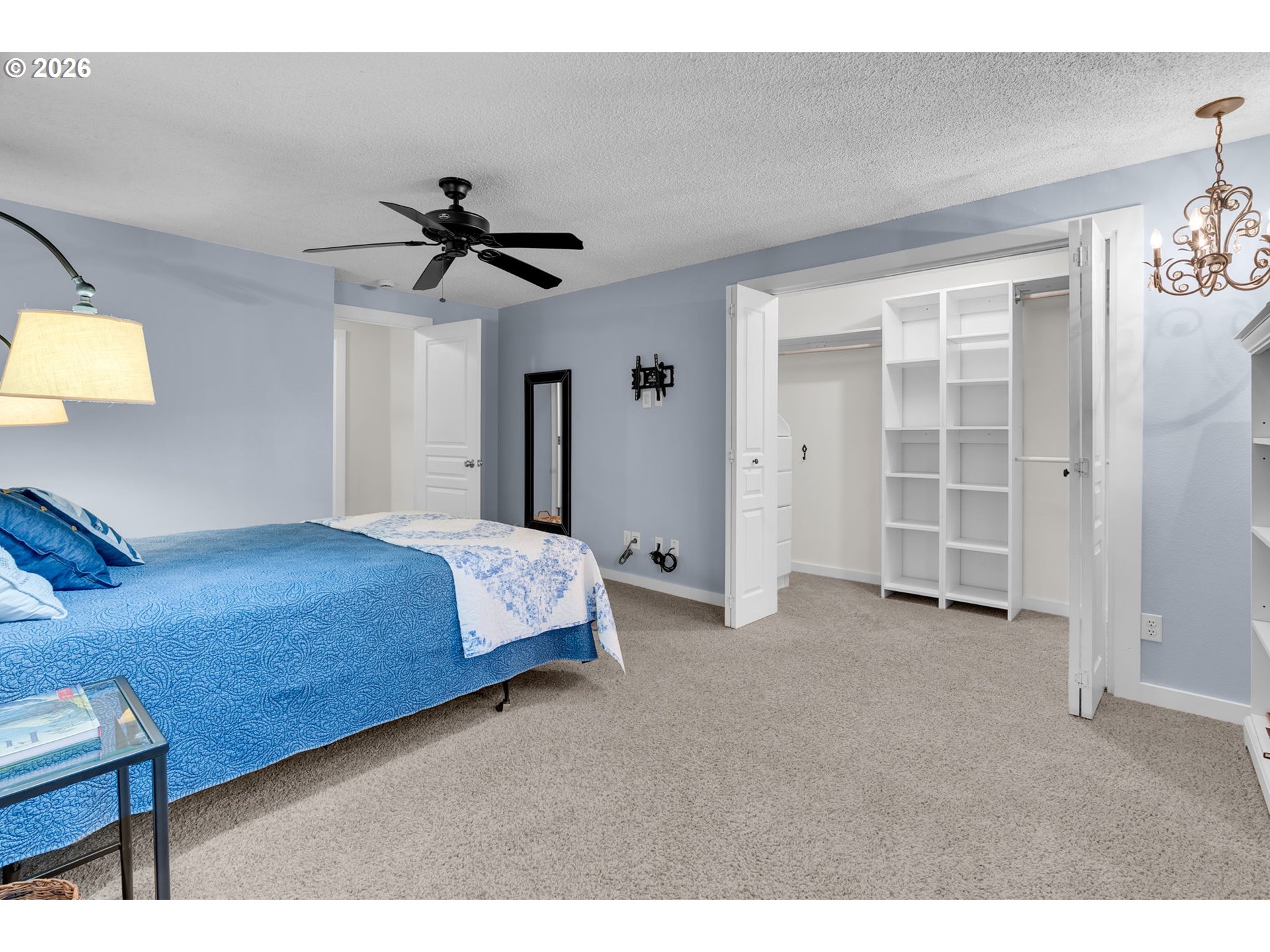 18370 Franklin Way Gladstone, OR 97027 - Photo 25 of 45 a bedroom with a bed and a chandelier