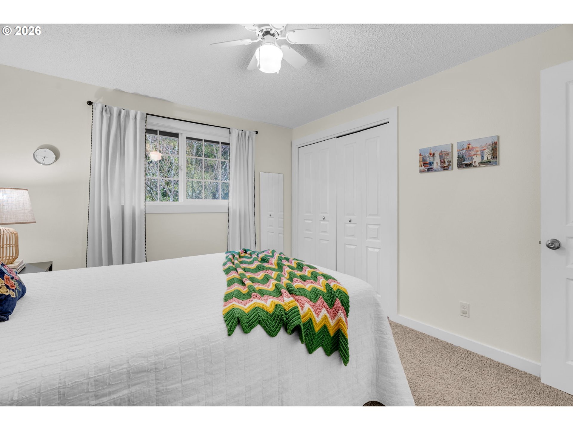 18370 Franklin Way Gladstone, OR 97027 - Photo 32 of 45 a bedroom with a bed and a chandelier