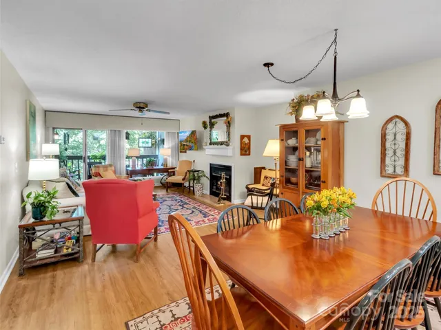 a dining room with furniture a fireplace and wooden floor