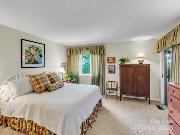 a bedroom with a large bed dresser and window