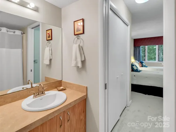 a en suite bathroom with a double vanity sink a mirror and a shower