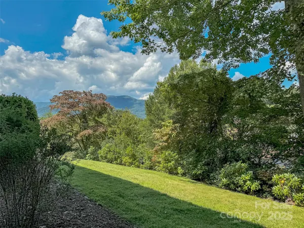 a view of a house with brick walls and trees