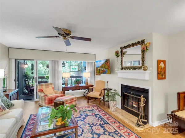 a living room with furniture fireplace and window