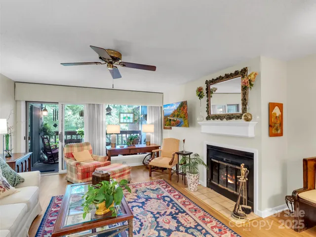 a living room with furniture fireplace and window