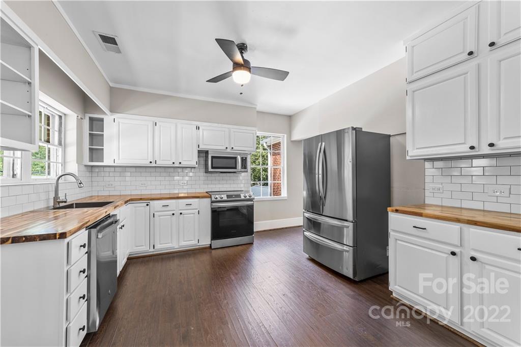 844 Lincolnton Road Salisbury, NC 28144 - Photo 12 of 36 a kitchen with granite countertop a refrigerator a sink a stove and cabinets
