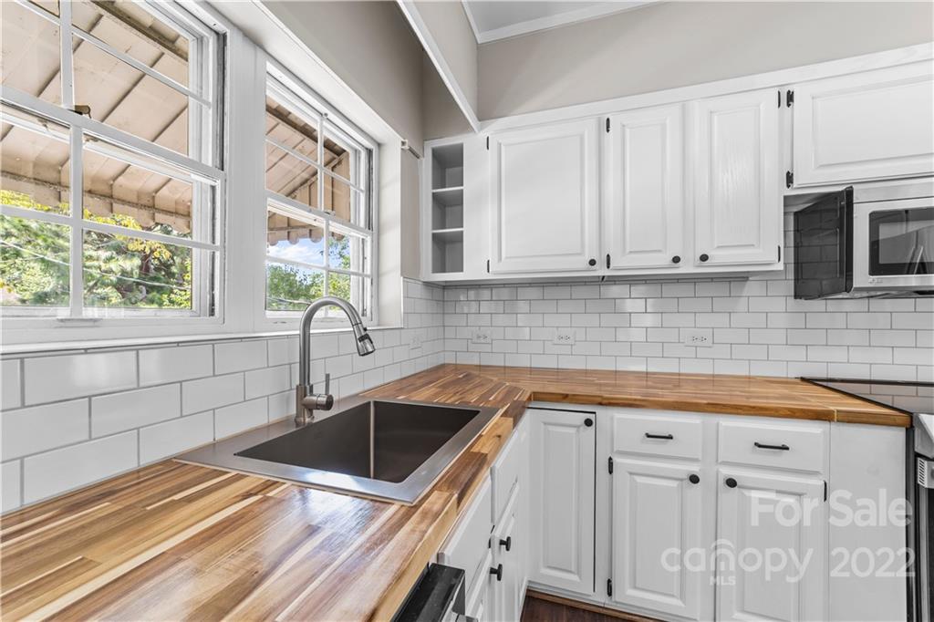 844 Lincolnton Road Salisbury, NC 28144 - Photo 14 of 36 a kitchen with granite countertop a sink a stove and cabinets