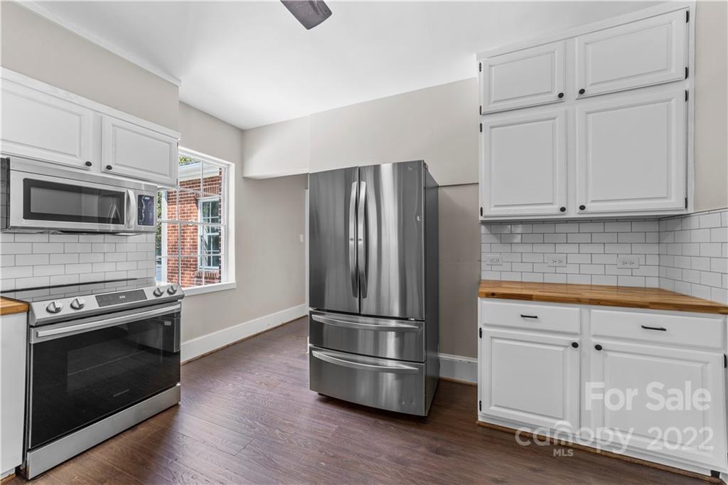 844 Lincolnton Road Salisbury, NC 28144 - Photo 15 of 36 a kitchen with granite countertop wooden floors stainless steel appliances and cabinets