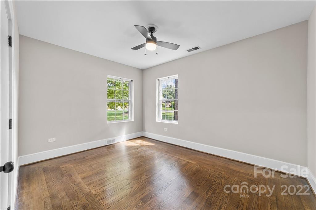 844 Lincolnton Road Salisbury, NC 28144 - Photo 18 of 36 an empty room with wooden floor chandelier fan and windows