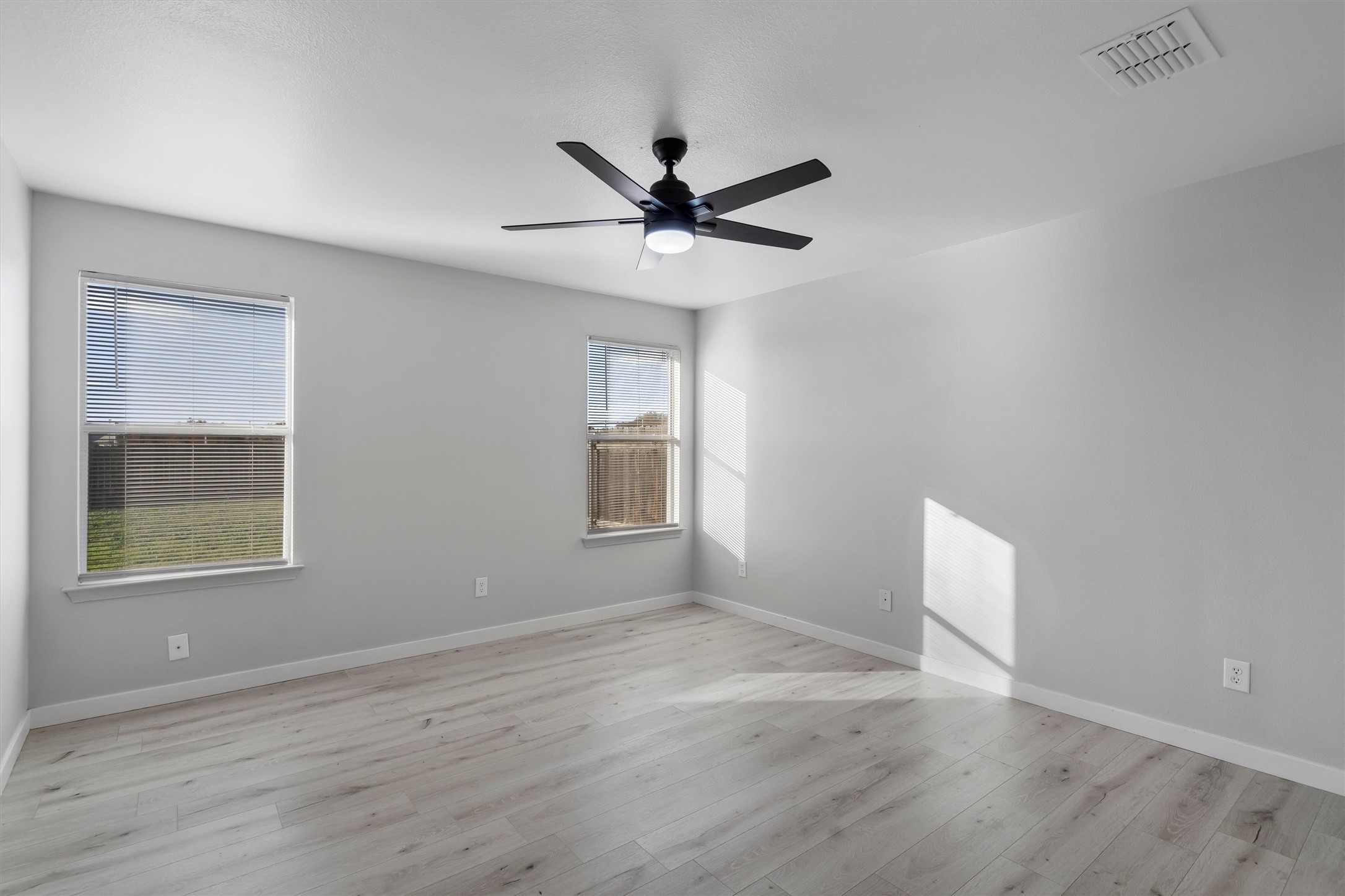 313 Drystone Trail Liberty Hill, TX 78642 - Photo 10 of 17 Empty room featuring ceiling fan and light wood-style floors