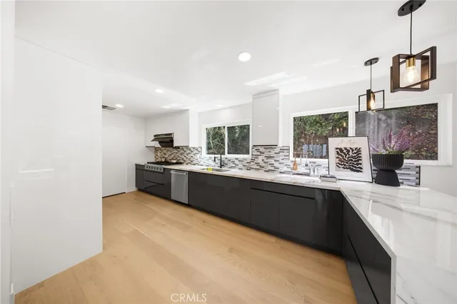 a kitchen with a sink cabinets and window