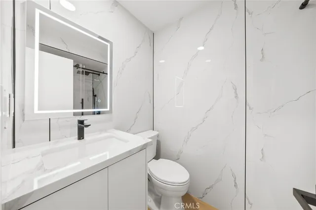 a view of an empty room with closet and a window