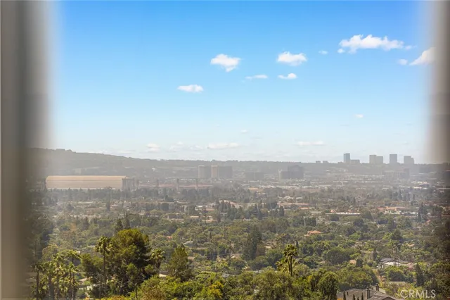 a bathroom with a granite countertop sink a toilet and a mirror