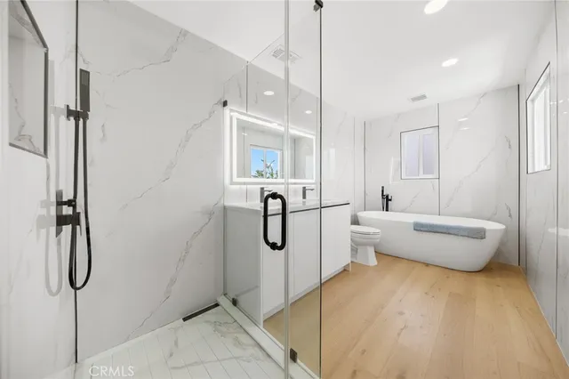 a bedroom with a bed and a couch