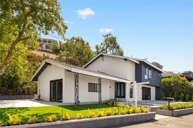 a view of a backyard with a garden and tree