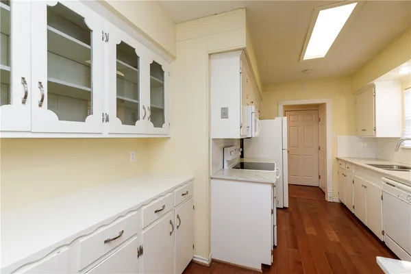 a kitchen with cabinets and wooden floor