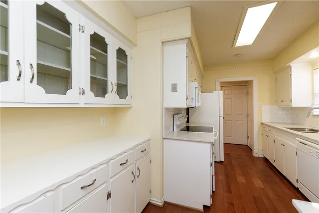 a kitchen with cabinets and wooden floor