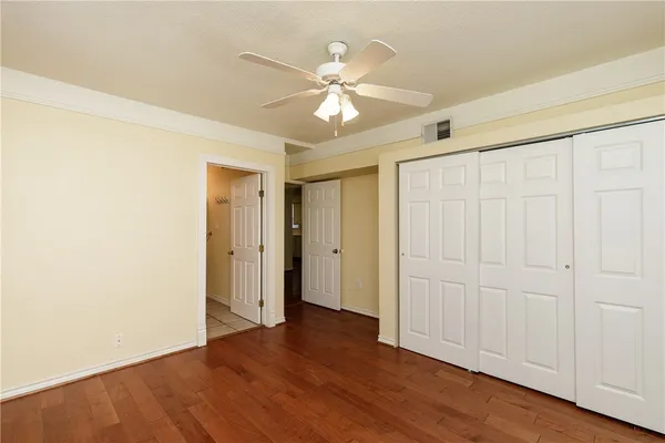 a view of an empty room with wooden floor
