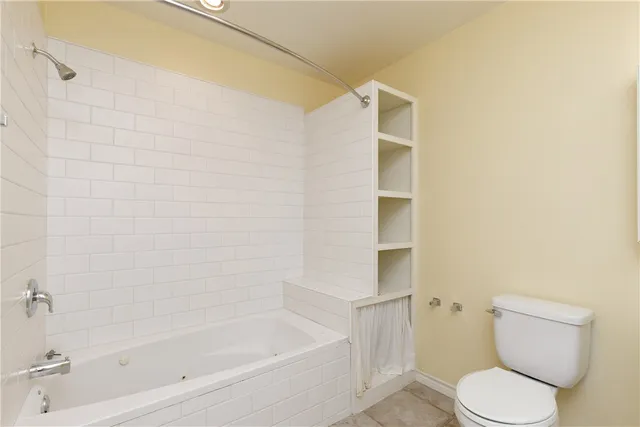 a bathroom with a toilet and a bathtub