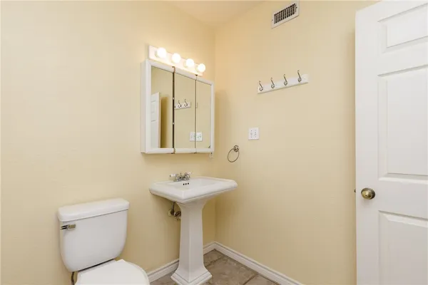 a bathroom with a sink mirror toilet and a mirror