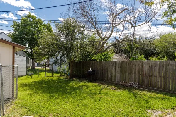 a backyard of a house with swimming pool and trees