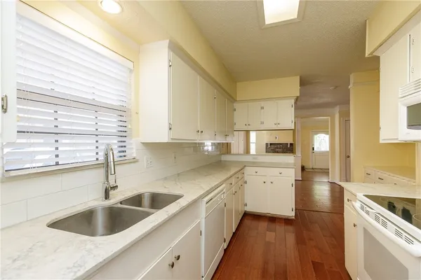 a kitchen with a sink cabinets a counter top space and stainless steel appliances