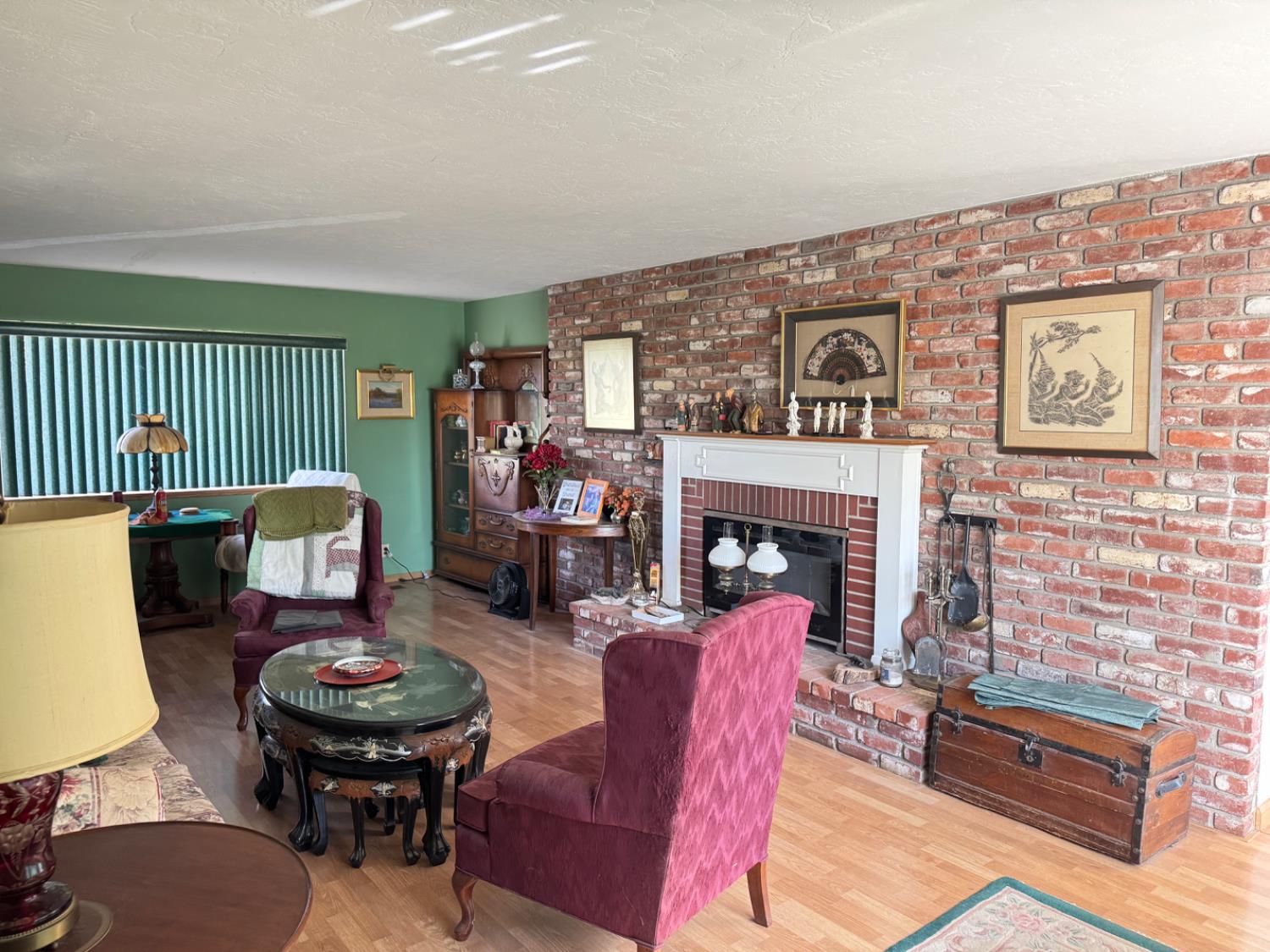 5476 Greenwood Avenue Clovis, CA 93619 - Photo 14 of 19 a living room with furniture a fireplace and a table