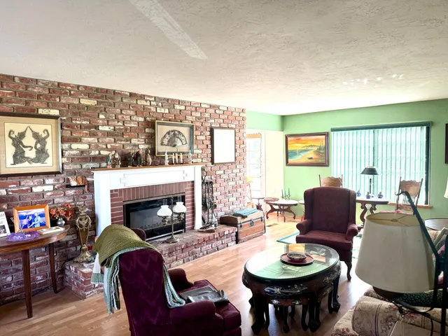 a dining room with furniture water view and wooden floor