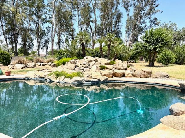 5476 Greenwood Avenue Clovis, CA 93619 - Photo 2 of 19 a view of a swimming pool with a yard
