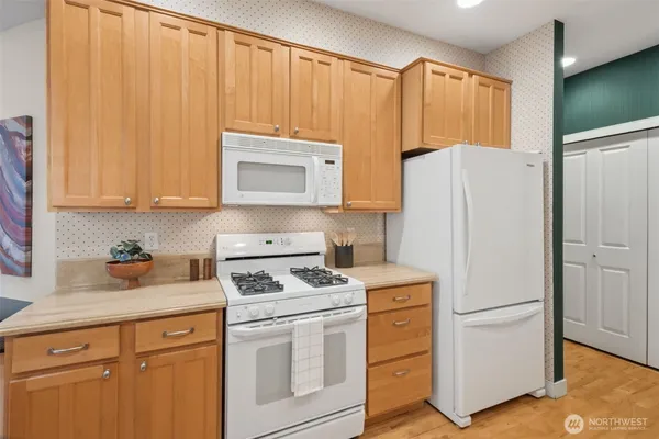 a kitchen with a refrigerator stove and microwave