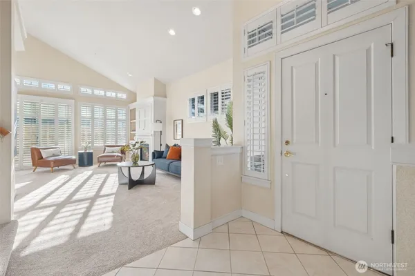 a view of a livingroom with furniture and floor to ceiling window
