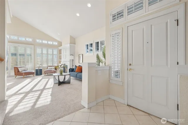 a view of a livingroom with furniture and floor to ceiling window