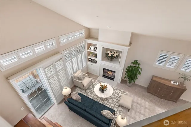 a living room with furniture and floor to dining table