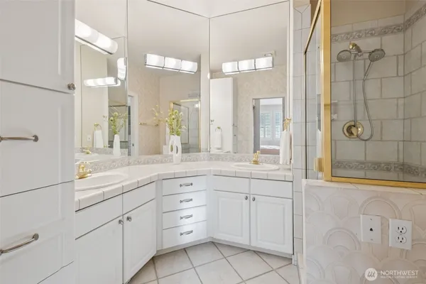 a bathroom with a granite countertop sink mirror and double