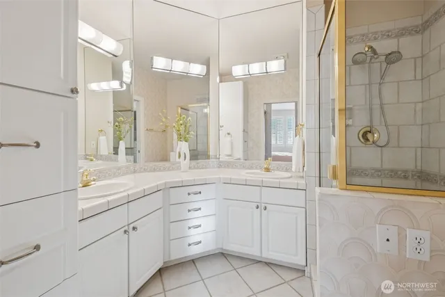 a bathroom with a granite countertop sink mirror and double