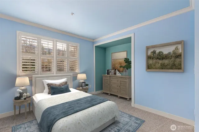 a bedroom with a bed and a large window